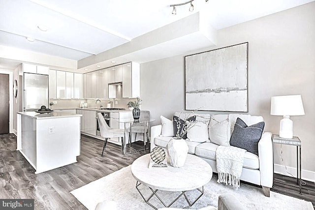 living area featuring dark wood-style floors and baseboards