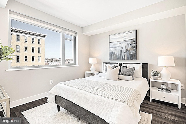 bedroom featuring baseboards and wood finished floors