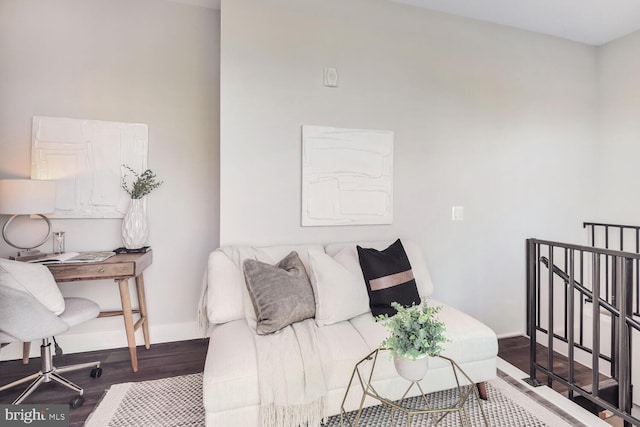 bedroom with wood finished floors and baseboards