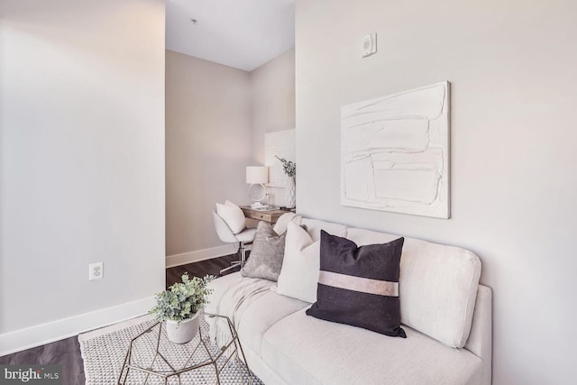 living room featuring baseboards and wood finished floors