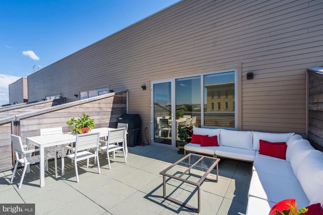 view of patio / terrace with outdoor dining space, an outdoor living space, and a grill