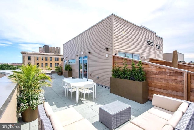 view of patio / terrace featuring a balcony, outdoor dining space, and outdoor lounge area