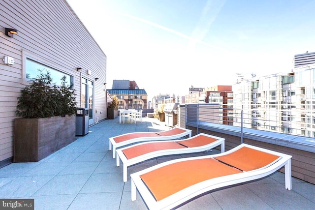 view of patio featuring a balcony and outdoor dining area