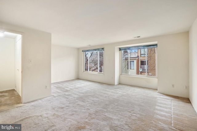 carpeted empty room with visible vents