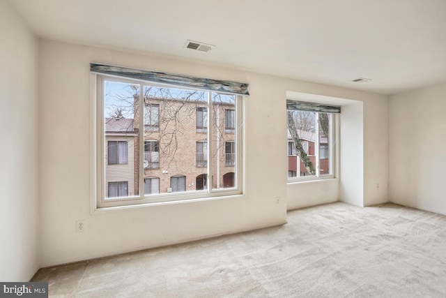 carpeted empty room with visible vents