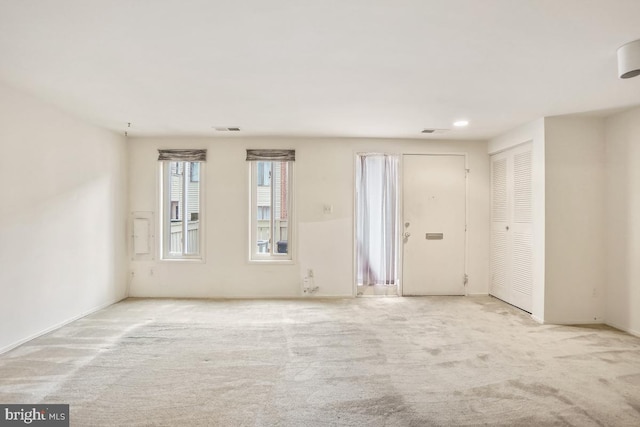 unfurnished room featuring visible vents and carpet