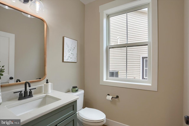 bathroom with vanity, a wealth of natural light, and toilet