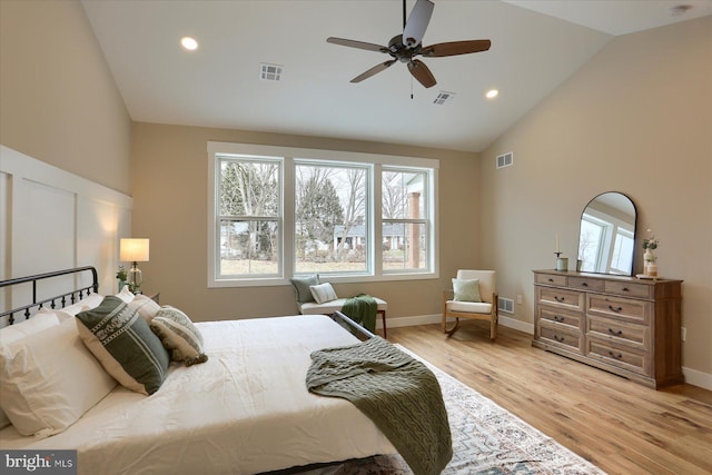 bedroom with multiple windows, light hardwood / wood-style flooring, high vaulted ceiling, and ceiling fan