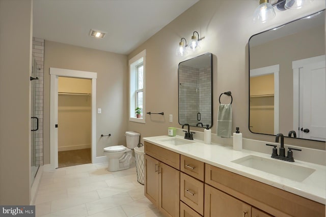 bathroom with vanity, toilet, and an enclosed shower