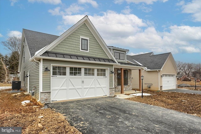 craftsman house with a porch, a garage, and cooling unit