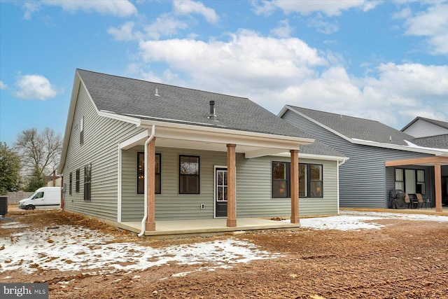 view of front of home with a porch and central AC