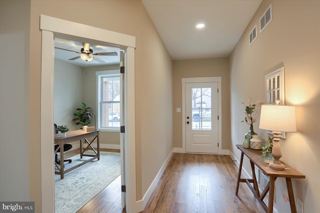 doorway featuring hardwood / wood-style flooring and ceiling fan