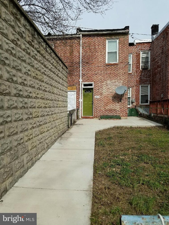 rear view of property with a yard and a patio