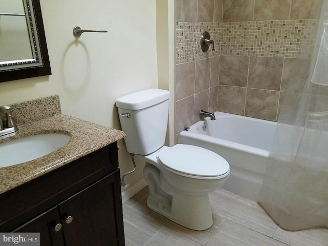 full bathroom featuring vanity, tiled shower / bath, tile patterned flooring, and toilet