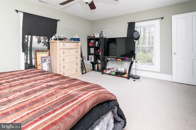 bedroom featuring ceiling fan and light colored carpet