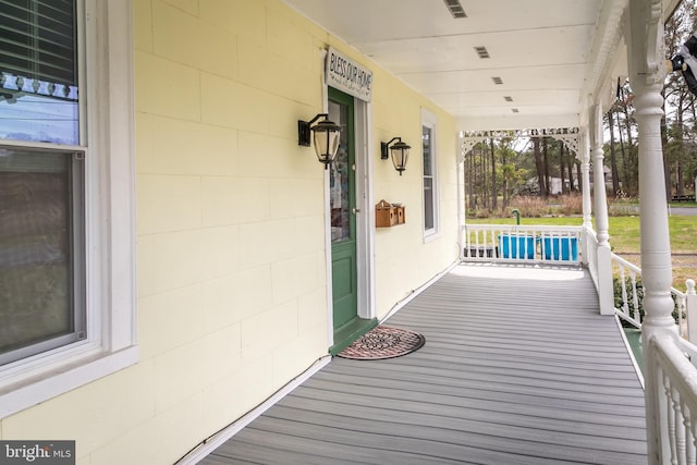 wooden terrace featuring covered porch