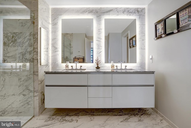 bathroom featuring marble finish floor, a sink, and a marble finish shower