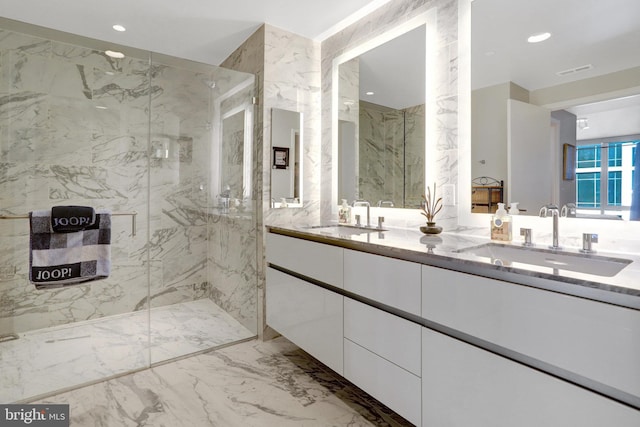 full bath with recessed lighting, marble finish floor, a sink, and stone wall