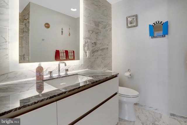 bathroom featuring marble finish floor, vanity, and toilet