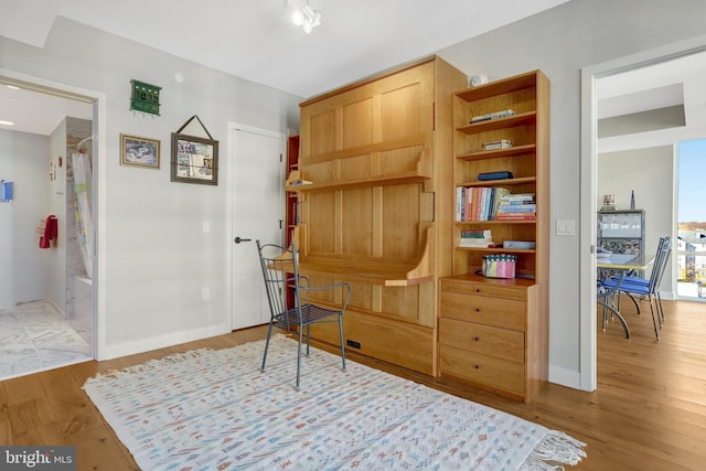 living area featuring wood finished floors and baseboards