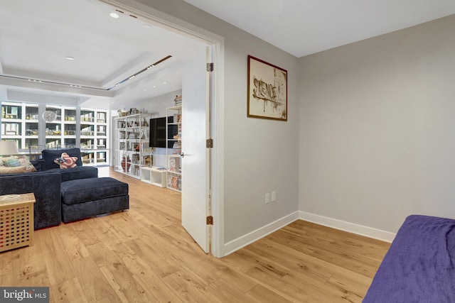 sitting room featuring light wood-type flooring and baseboards