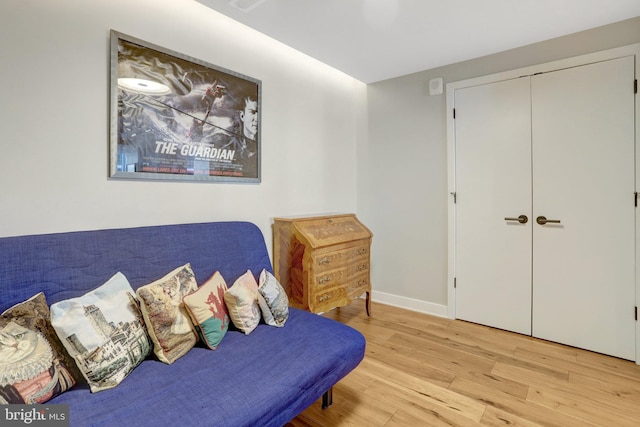 bedroom featuring baseboards, a closet, and light wood-style floors