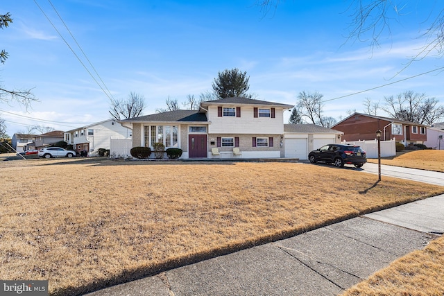 view of front facade featuring a front lawn and a garage