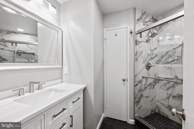 bathroom featuring vanity and a shower with door