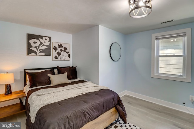 bedroom with hardwood / wood-style floors