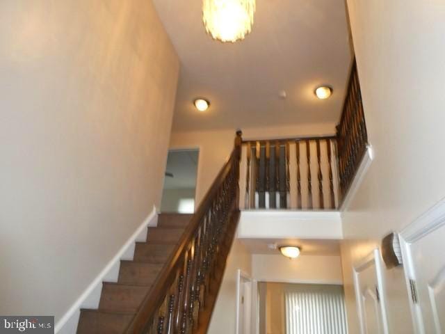 stairs featuring a towering ceiling