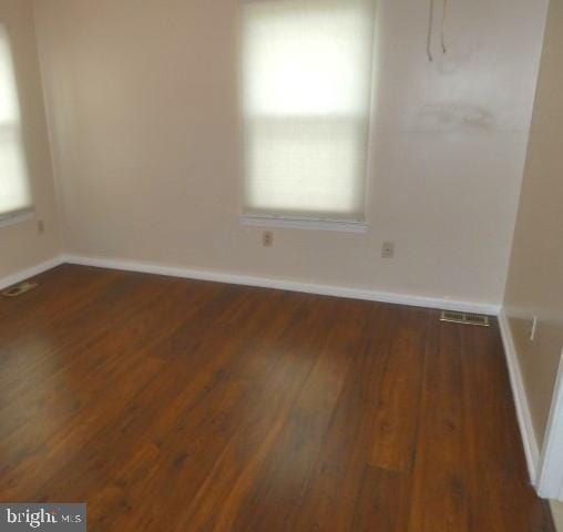 spare room featuring dark hardwood / wood-style floors