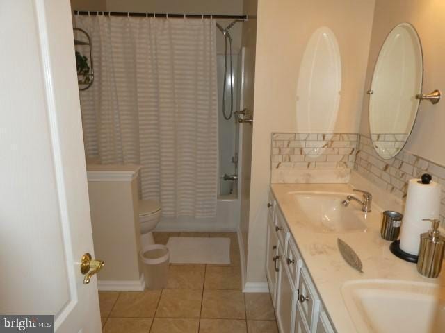 full bathroom featuring tile patterned floors, shower / bath combo, toilet, vanity, and decorative backsplash