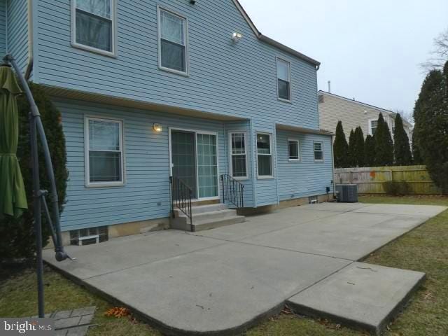 rear view of property with a patio area and central air condition unit