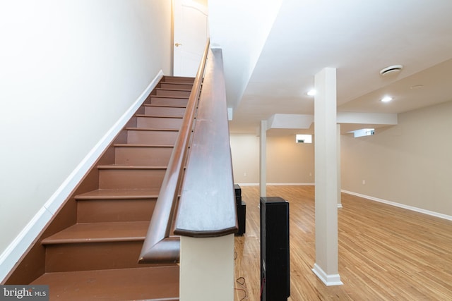 staircase featuring wood-type flooring