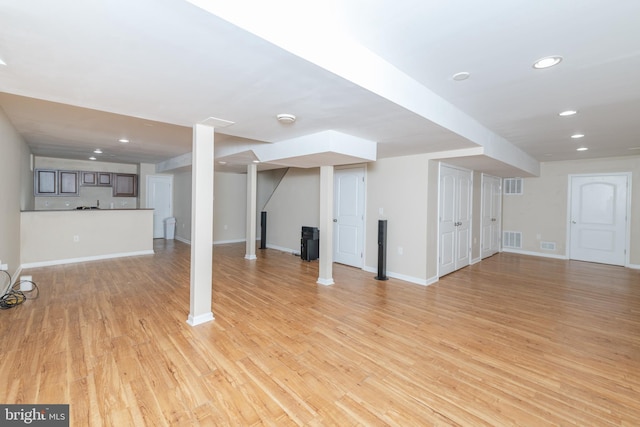 basement with light hardwood / wood-style floors