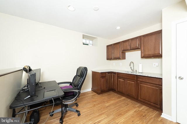 office area featuring light hardwood / wood-style flooring and sink