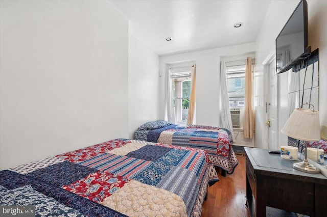 bedroom with dark hardwood / wood-style floors