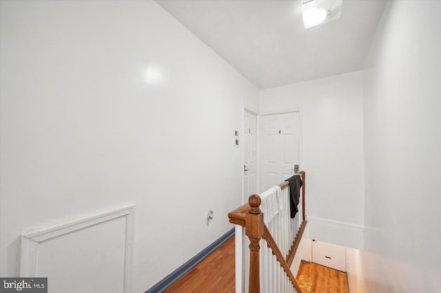 corridor with hardwood / wood-style floors