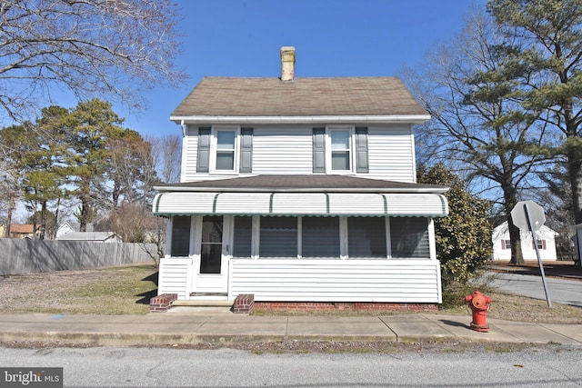 view of front of property featuring fence