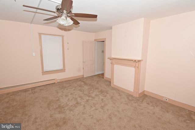 spare room featuring light carpet, ceiling fan, a baseboard heating unit, and baseboards