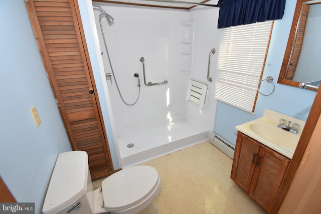 bathroom featuring a baseboard heating unit, a closet, a shower stall, and vanity