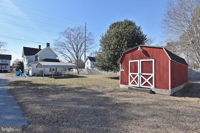 view of shed featuring fence