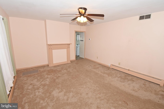 carpeted empty room featuring a baseboard heating unit, visible vents, ceiling fan, and baseboards