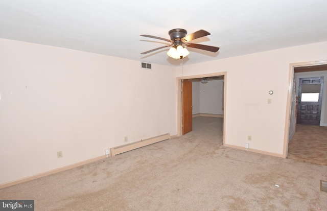 unfurnished bedroom featuring light carpet, visible vents, baseboards, and baseboard heating