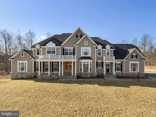 craftsman-style house with a porch and a front yard