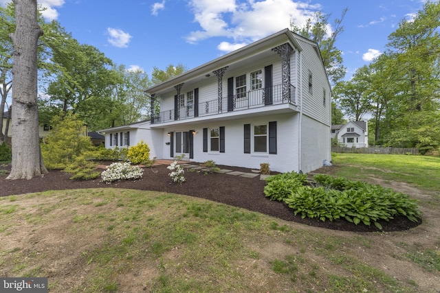9301 Reef Ct, Alexandria, VA 22309 - view of front of home featuring a front lawn, brick siding, fence, and a balcony
