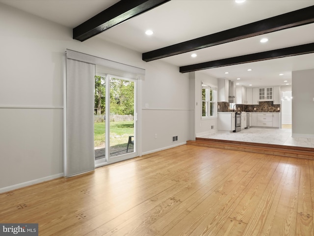 9301 Reef Ct, Alexandria, VA 22309 - unfurnished living room featuring light wood-type flooring, beamed ceiling, recessed lighting, and baseboards