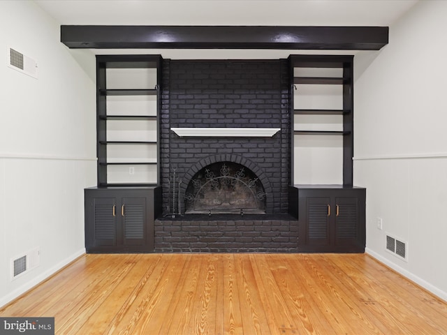 9301 Reef Ct, Alexandria, VA 22309 - unfurnished living room with wood finished floors, a wainscoted wall, beam ceiling, a fireplace, and baseboards