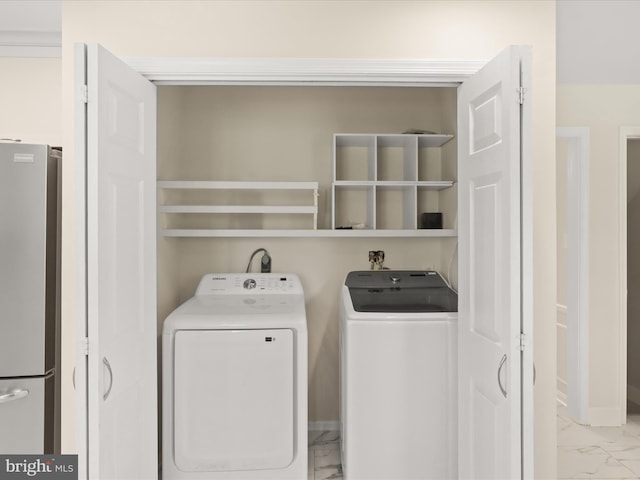 9301 Reef Ct, Alexandria, VA 22309 - laundry room featuring light marble finish floors and washing machine and clothes dryer