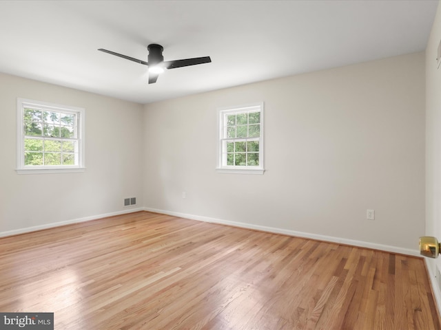 9301 Reef Ct, Alexandria, VA 22309 - empty room featuring healthy amount of natural light, light wood finished floors, ceiling fan, and baseboards
